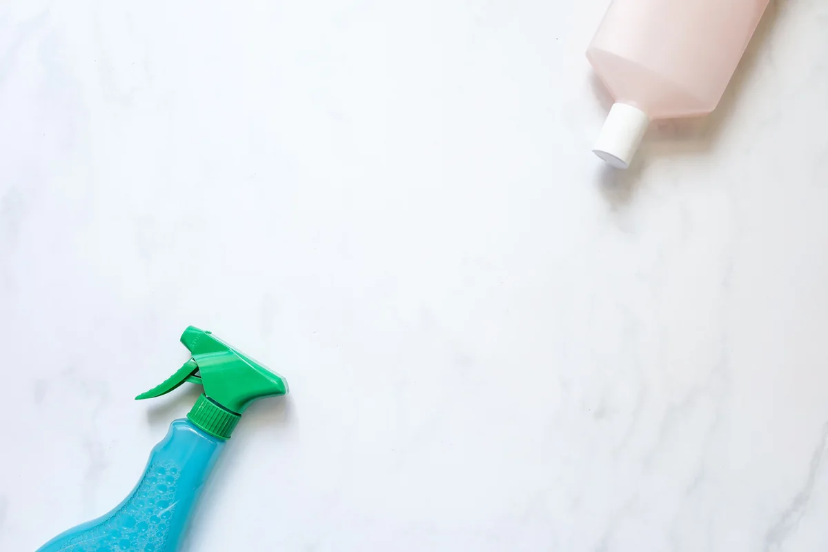 Household cleaning products arranged safely on a clean surface